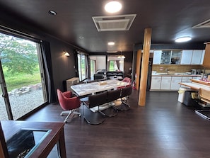 A modern kitchen with a dining area, large windows, and a view of the outdoors. - Cool-villa HIDA resort (Hida)