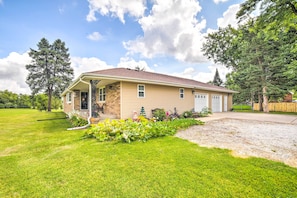 A single-story house with a front porch, a garage, and a well-maintained lawn.