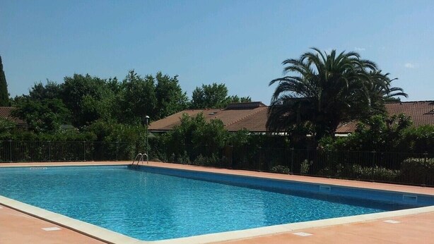A rectangular swimming pool with a clear blue water surface, surrounded by a concrete deck. - Pool pavilion in private residence (Argelès-sur-Mer)