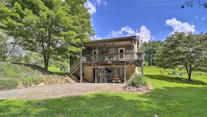 A two-story house with a balcony, a covered porch, and a front door. - Deep Gap Cottage w/ Fire Pits - Hike & Ski! (Deep Gap)