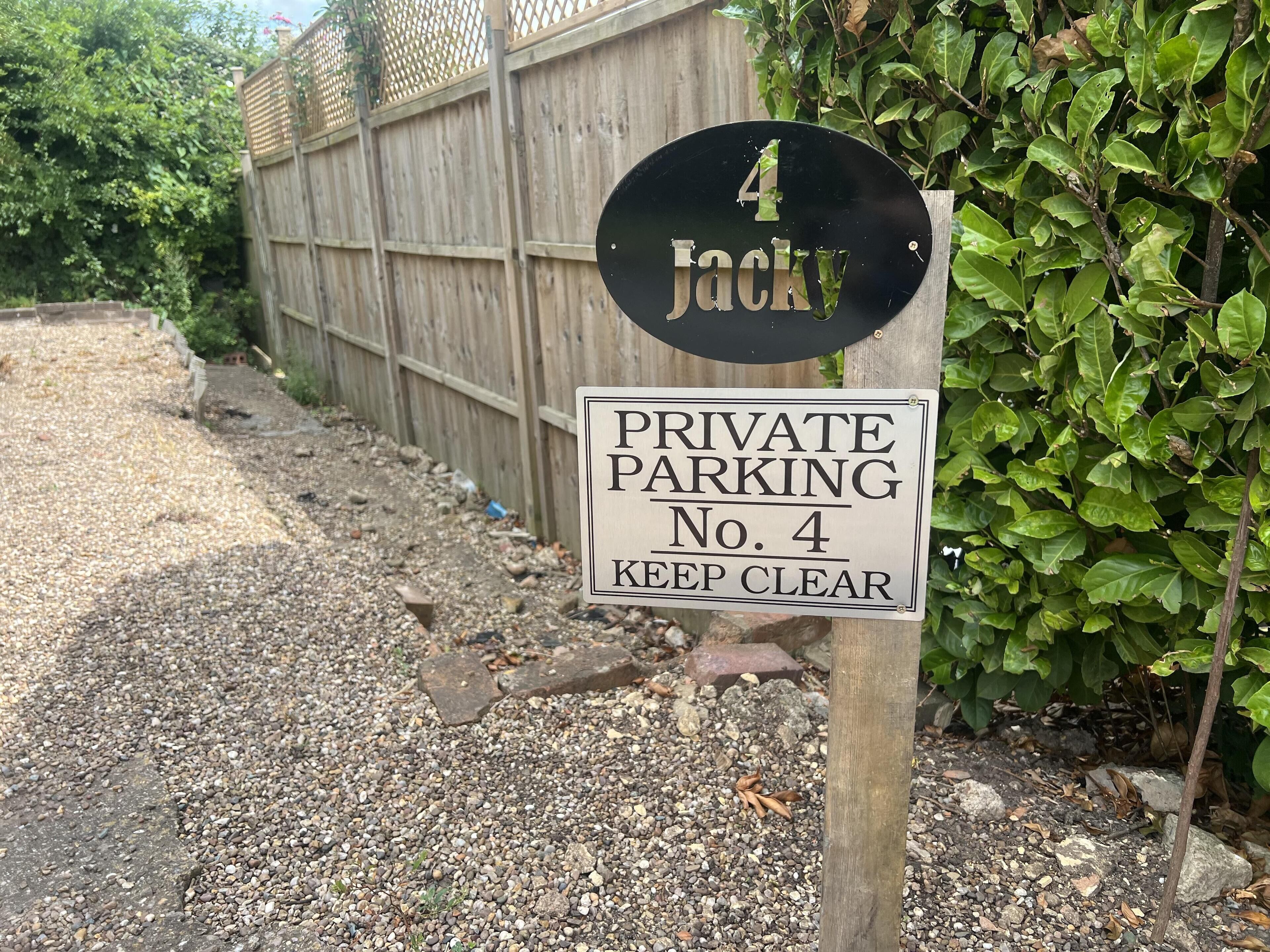 A private parking sign with the number 4 and the name 'Jacky'.