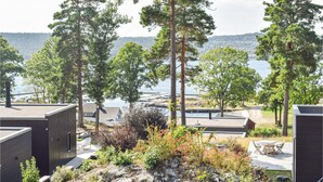 A lakeside property with cabins, a deck, and a view of the water.
