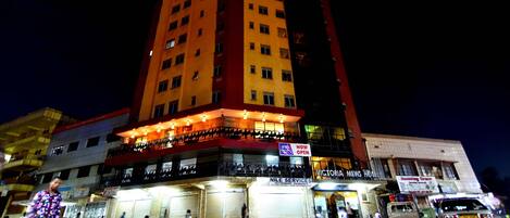 A multi-story hotel with a prominent sign reading "Victoria Mews Hotel."