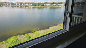 A view of a lake with a building in the background. - Beautifully renovated lakefront condo! Executive Rental, Monthly Rental (Lake Suzy)