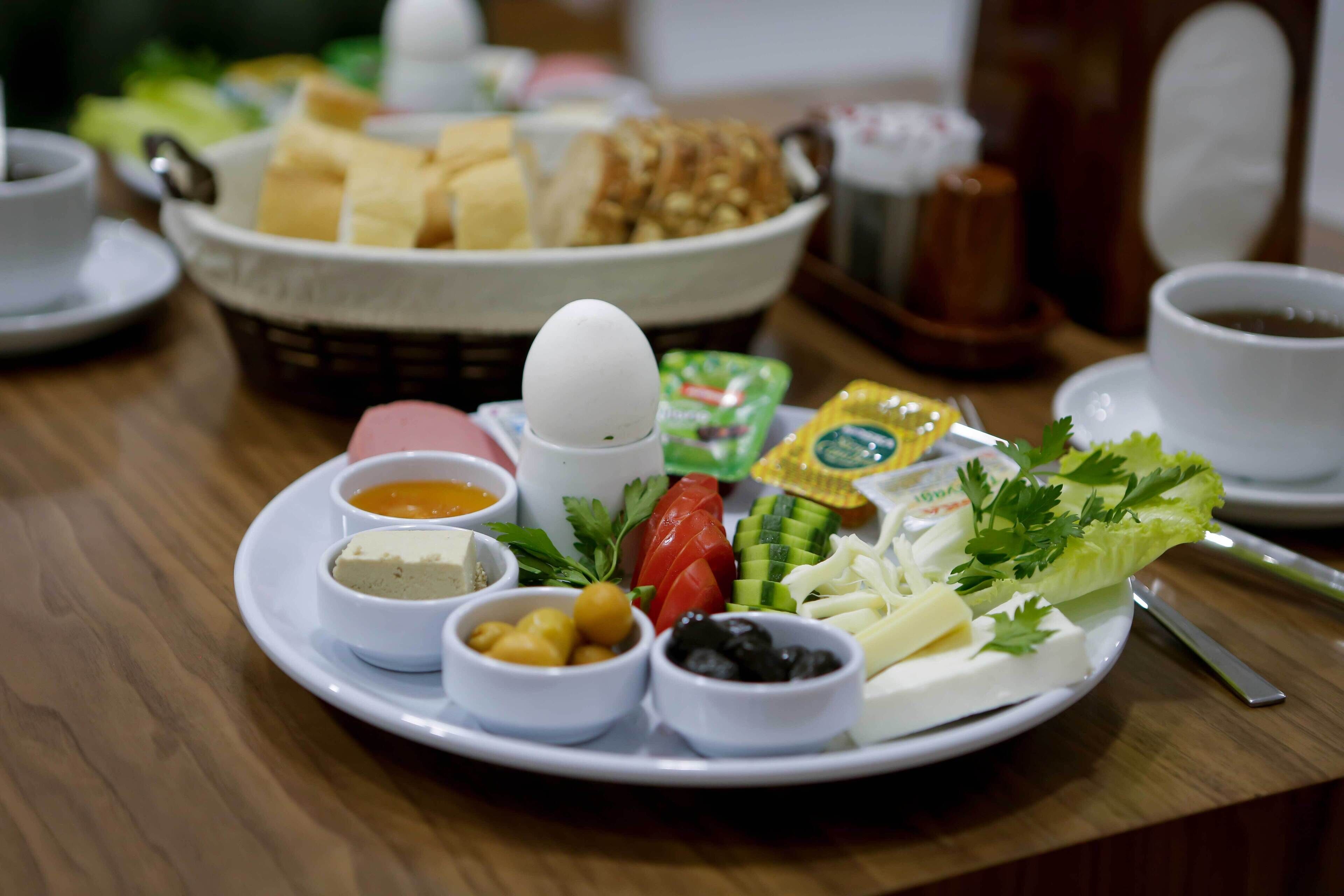 A breakfast plate with various foods and condiments.