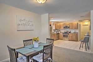 A modern kitchen with wooden cabinets, a microwave, and a built-in oven.
