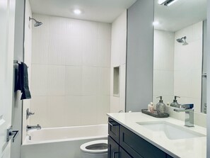 Combined shower/tub, hair dryer, towels, soap