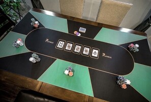 A poker table with chips and playing cards, branded with "PLAYWUS." - Inviting Sunny House! Poker table~ 4br 3ba 7 beds/ 10 mins to Airport & Strip! (Las Vegas)