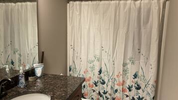 Combined shower/tub, hair dryer, towels, soap