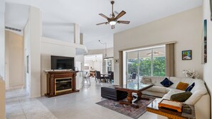 A spacious living room with a fireplace, a sofa, a coffee table, and a television. - Sea Glass Serenity, 3+2, Nokomis Beach, Heated Pool (Nokomis)