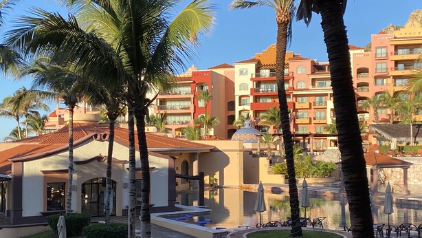 A resort with multiple buildings, palm trees, and a pool area. - 5 minutes walking distance to Cabo Marina yet private w/security (Cabo San Lucas)