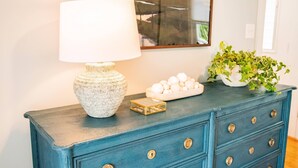 A blue dresser with a white lamp, a small tray of eggs, and a potted plant. - JULY DISCOUNT! Romantic 2 BR 2 story w/mountain views and stunning outdoor space (Amherst)