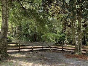 Sit and unwind in a shaded resting area surrounded by lush greenery and mature trees.