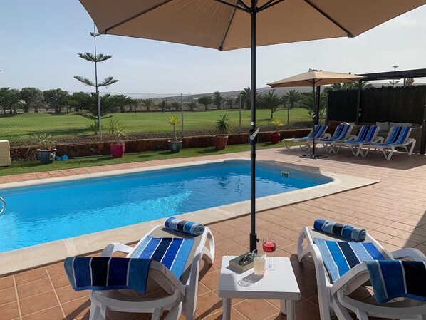 Outdoor pool, a heated pool, sun loungers