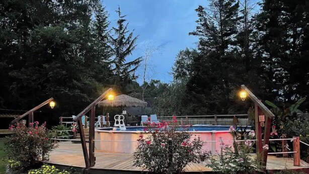 A swimming pool with a wooden deck, surrounded by greenery and trees. - Etowah River, Berry & Shorter College, Tennis, Trails-3 miles from Broad St. (Rome)