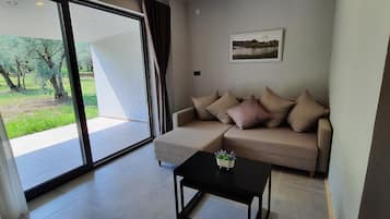 Deluxe Suite, Lake View | Living area | Smart TV