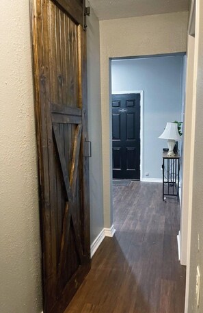 Enter a standard hotel room with a door leading to a space.