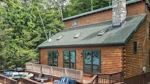 A log cabin with a deck, outdoor seating, and a chimney. - Waterfront at Winnipesaukee with incredible views!! Boat Required (Alton)