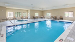 A large indoor swimming pool with multiple lanes, surrounded by lounge chairs and tables. - 1 Bedroom | Breakfast Buffet. Pool & Hot Tub (Canton)