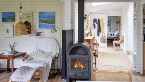 A cozy room with a fireplace, a bed, a desk, and a chair. - 3 bedroom awesome home in Anholt (Anholt)