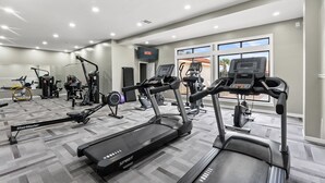 A gym with treadmills, ellipticals, and weight machines. - First Floor • Walk to Beach • Sleeps 6 (Panama City Beach)