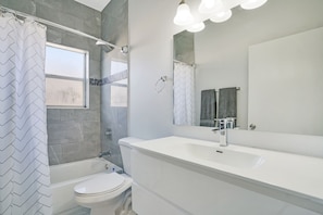 Bathtub, towels, soap, toilet paper