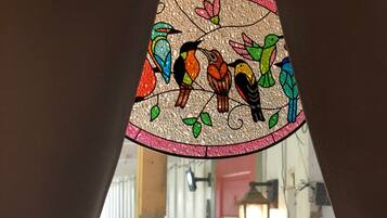 A stained glass window with colorful birds.