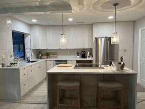 Enjoy cooking in this well-equipped kitchen with a central island and stainless steel appliances.
