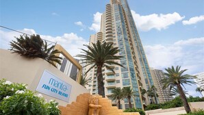 A high-rise building with a sign reading "Manta Sun City Resort". - Sun City - Q Stay (Surfers Paradise)