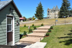 A small building with a door and steps leading to a grassy area. - Completely Renovated Home with Mountain Views (White Sulphur Springs)
