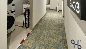 A hallway with a washing machine, a small table, and a sign with '3A03'. - Homi Breeze 和逸微风 (Kota Kinabalu)