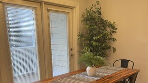A dining table with a wooden top and black metal legs, surrounded by black chairs. - Elegant Mountain Townhome in Banner Elk (Banner Elk)