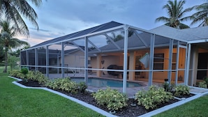 A modern house with a covered outdoor area, a swimming pool, and well-maintained landscaping. - ---BEAUTIFUL TROPICAL GARDEN HEATED POOL HOME ---
/AN OPTION BOAT RENTAL (Cape Coral)