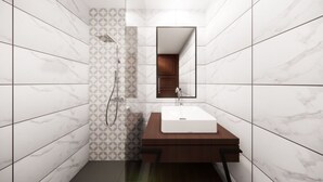 A modern bathroom with white marble tiles, a wooden vanity, a white sink, and a shower with a geometric tile pattern.