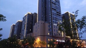 A high-rise building with multiple floors, likely a hotel or residential complex. - Tongxilai Hotel (Jingyan)