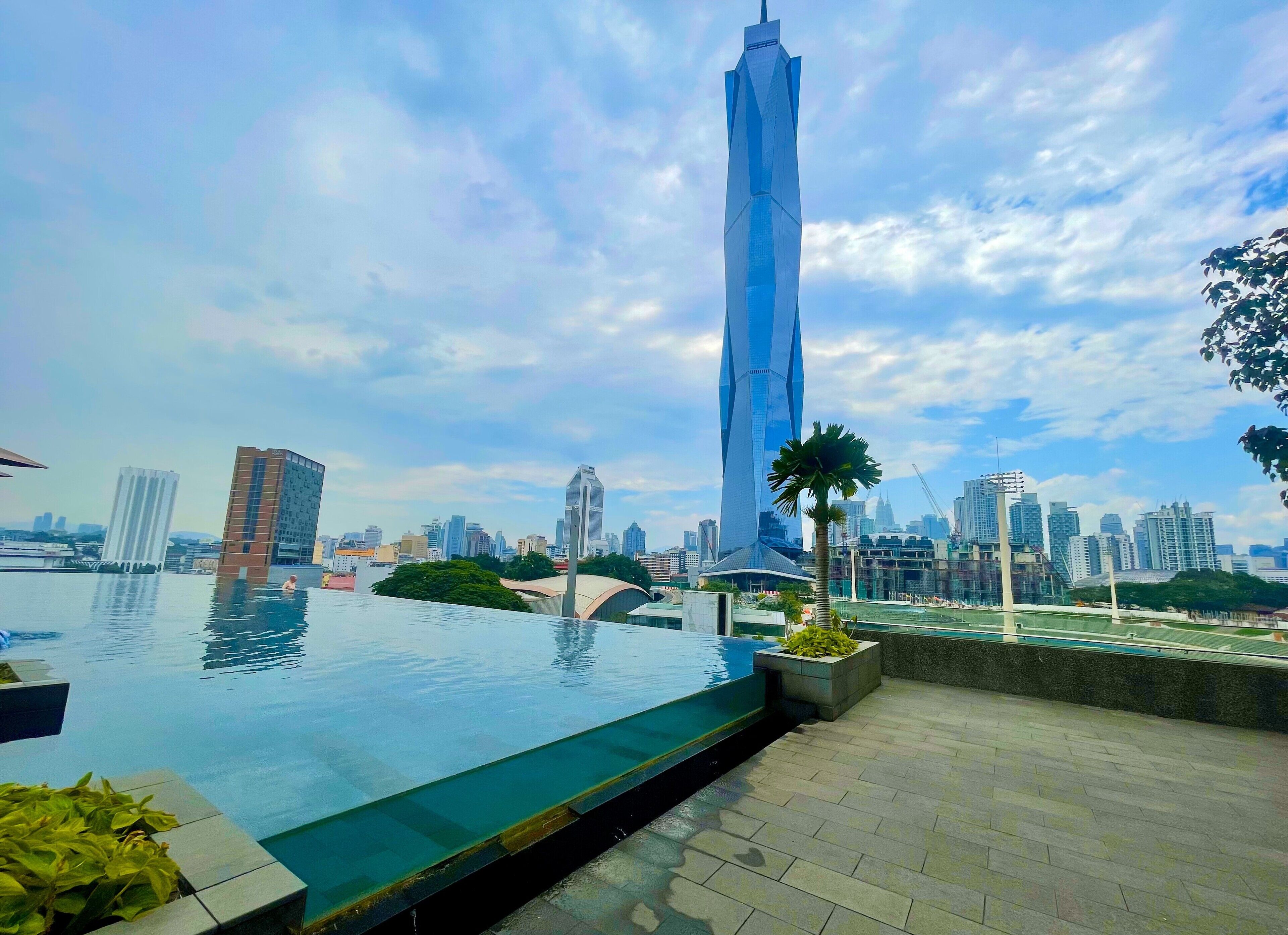 An infinity pool with a city skyline in the background.