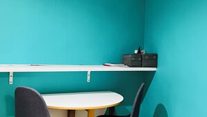 A small room with teal walls, a white table, and two chairs. - Arts-et-Métiers: 5 minutes walk from rue Rambuteau (Paris)