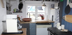 Fridge, stovetop, dishwasher, coffee/tea maker
