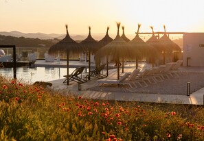 Outdoor pool, open 9:00 AM to 9:00 PM, pool umbrellas, pool loungers