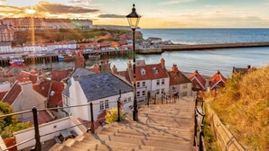 A coastal town with a prominent staircase leading down to the waterfront, a pier, and a historic building in the background. - Rowan 6m xl Bell Tent (Saltburn-by-the-Sea)
