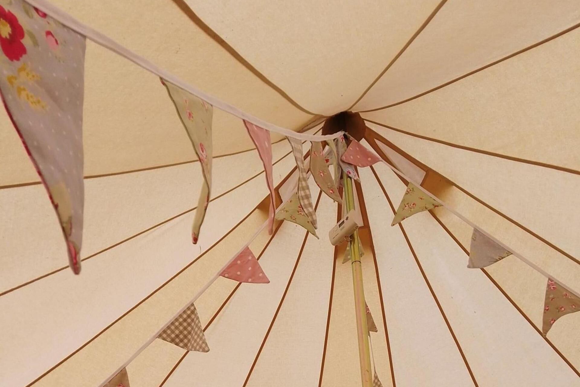 A ceiling with a series of triangular flags hanging from it.