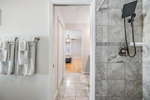 Combined shower/bathtub, towels, toilet paper