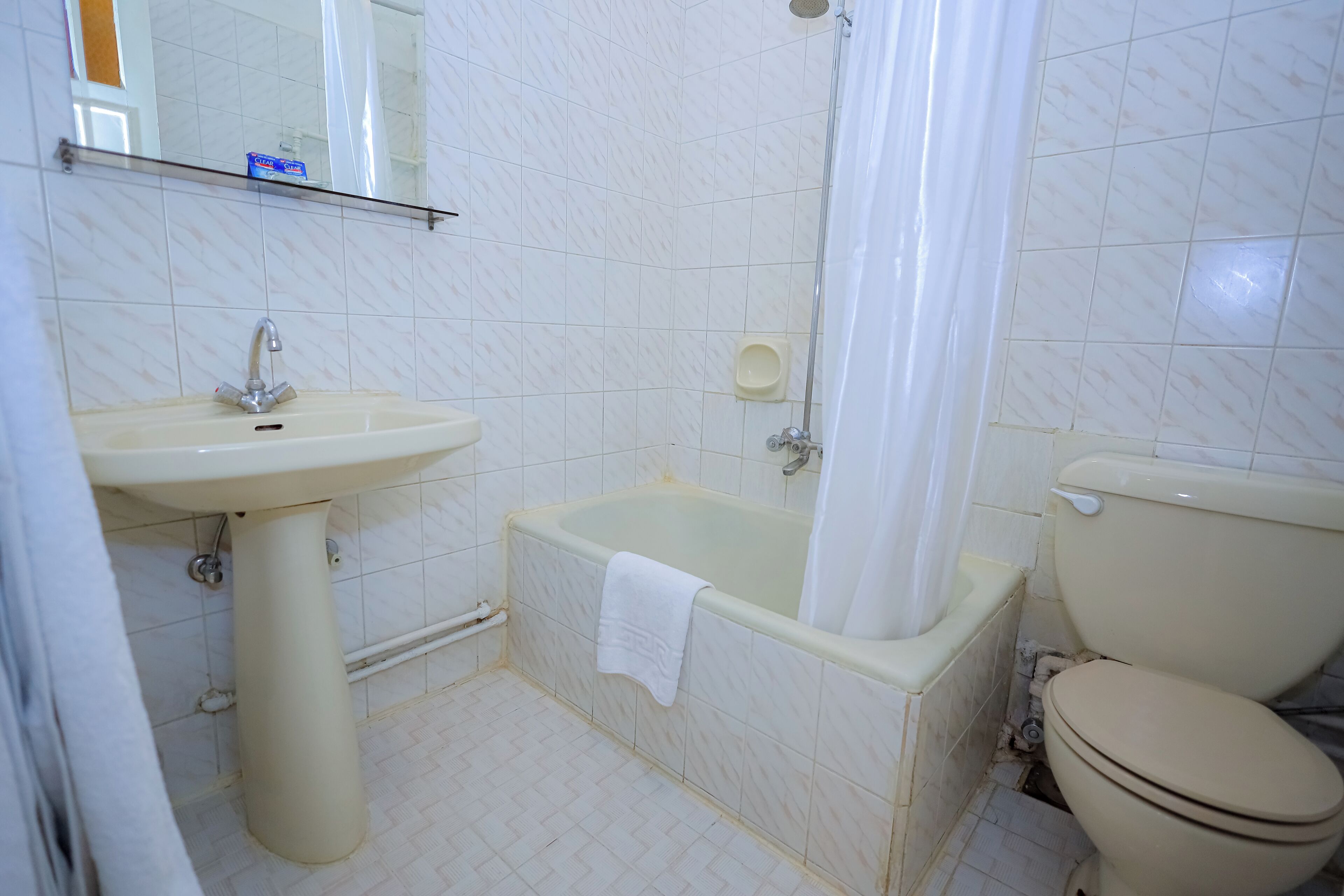 A bathroom with a sink, bathtub, and toilet.