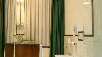 A modern bathroom with a freestanding bathtub, a vanity with a mirror, and a toilet.