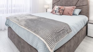 A modern bedroom with a large bed, a bedside table, and a window with sheer curtains. - Paradise Porto apartment with terrace in the center of Porto (Porto)
