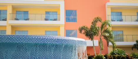 A Courtyard by Marriott hotel with a pool area featuring a mosaic tile edge.