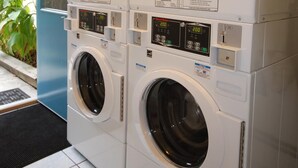 A stacked washer and dryer unit with digital displays and operating instructions. - CCK Modern Studio Walkable to Midtown 1 Block From Marta (Atlanta)
