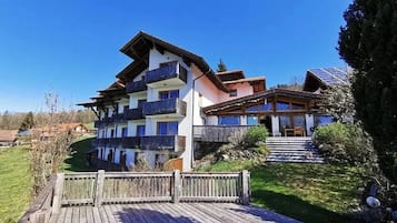 Experience the charm of the Alps from our ground-floor balcony, overlooking lush green surroundings.
