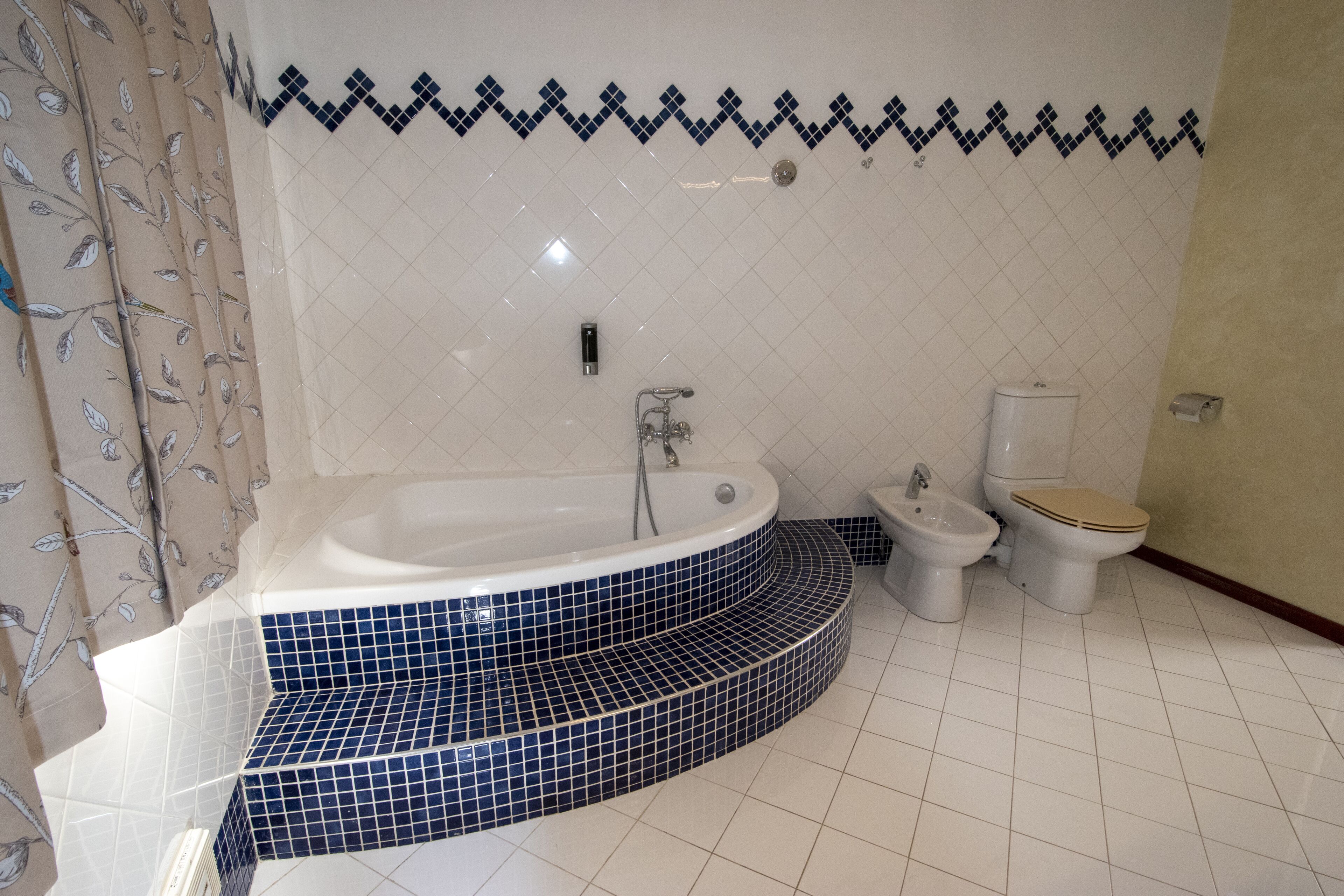 A bathroom with a freestanding bathtub, a bidet, and a toilet.