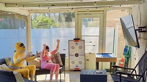 A covered outdoor area with seating, a foosball table, and a pool table. - "The Peach" *Family Friendly Oasis  *Pets Welcome (Pooler)